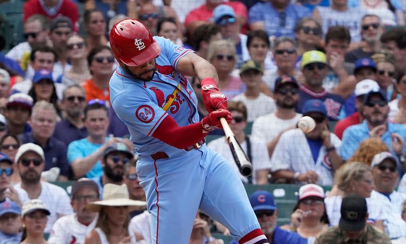 Aug 3, 2024; Chicago, Illinois, USA; St. Louis Cardinals outfielder Tommy Pham (29) hits a triple against the Chicago Cubs during the ninth inning at Wrigley Field. Mandatory Credit: David Banks-USA TODAY Sports