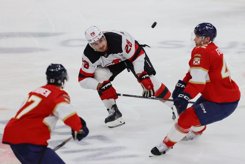 Nov 14, 2024; Sunrise, Florida, USA; New Jersey Devils right wing Timo Meier (28) battles for the puck against Florida Panthers defenseman Gustav Forsling (42) during the third period at Amerant Bank Arena. Mandatory Credit: Sam Navarro-Imagn Images