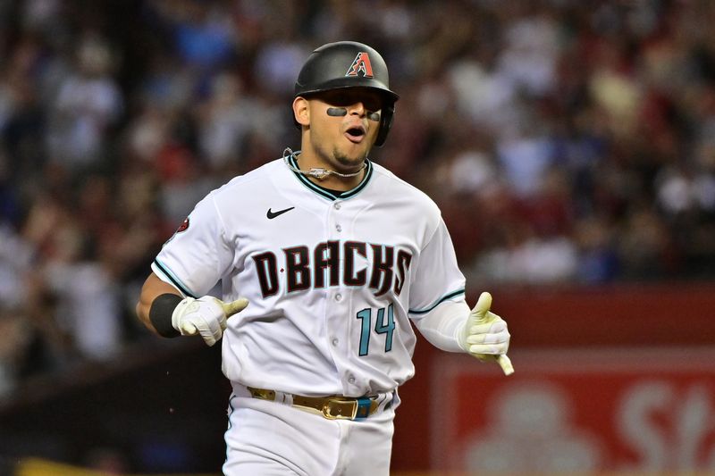 Oct 11, 2023; Phoenix, Arizona, USA; Arizona Diamondbacks catcher Gabriel Moreno (14) reacts after hitting a home run against the Los Angeles Dodgers in the third inning for game three of the NLDS for the 2023 MLB playoffs at Chase Field. Mandatory Credit: Matt Kartozian-USA TODAY Sports