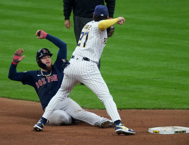 Apr 23, 2023; Milwaukee, Wisconsin, USA; Boston Red Sox right fielder Alex Verdugo (99) is unable to breakup a double play by Milwaukee Brewers shortstop Willy Adames (27) during the seventh inning of their game against the Boston Red Sox at American Family Field. Mandatory Credit: Mark Hoffman-USA TODAY Sports