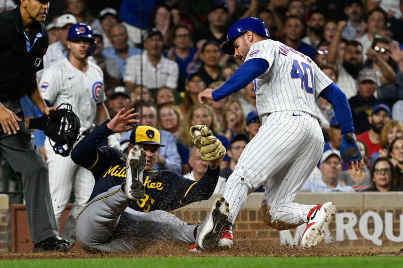 Jul 22, 2024; Chicago, Illinois, USA;  Chicago Cubs outfielder Mike Tauchman (40) scores past Milwaukee Brewers pitcher Tobias Myers (36) on a wild pitch during the fourth inning at Wrigley Field. Mandatory Credit: Matt Marton-USA TODAY Sports