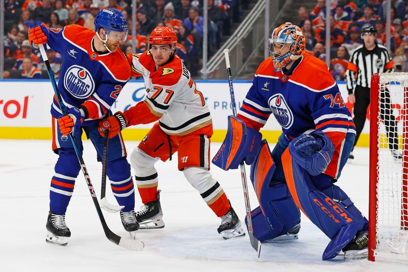 Jan 3, 2025; Edmonton, Alberta, CAN; Anaheim Ducks forward Frank Vatrano (77) battles for position with Edmonton Oilers defensemen Brett Kulak (27) in front of goaltender Stuart Skinner (74) during the second period at Rogers Place. Mandatory Credit: Perry Nelson-Imagn Images