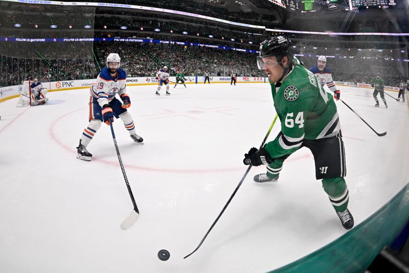 May 21, 2025; Dallas, Texas, USA; Dallas Stars center Mikael Granlund (64) skates with the puck against Edmonton Oilers center Adam Henrique (19) in the second period during game one of the Western Conference Final of the 2025 Stanley Cup Playoffs at American Airlines Center. Mandatory Credit: Jerome Miron-Imagn Images