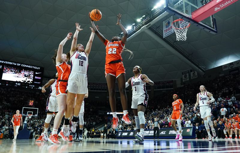 Mar 25, 2024; Storrs, Connecticut, USA; Syracuse Orange forward Kyra Wood (22) and UConn Huskies guard Ashlynn Shade (12) work for the rebound in the second half at Harry A. Gampel Pavilion. Mandatory Credit: David Butler II-USA TODAY Sports