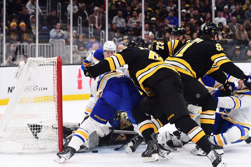 Oct 30, 2025; Boston, Massachusetts, USA;  Boston Bruins goaltender Joonas Korpisalo (70) tries to tie up a loose puck during the second period against the Buffalo Sabres  at TD Garden. Mandatory Credit: Bob DeChiara-Imagn Images