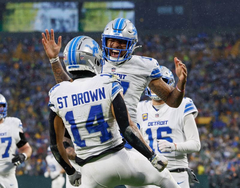 Detroit Lions wide receiver Amon-Ra St. Brown (14) reacts with Detroit Lions wide receiver Tim Patrick (17) after catching a touchdown against the Green Bay Packers during the first half of an NFL football game Sunday, Nov. 3, 2024, in Green Bay, Wis. (AP Photo/Jeffrey Phelps