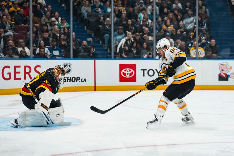 Jan 3, 2026; Vancouver, British Columbia, CAN; Vancouver Canucks goalie Kevin Lankinen (32) makes a save on Boston Bruins forward David Pastrnak (88) in the first period at Rogers Arena. Mandatory Credit: Bob Frid-Imagn Images