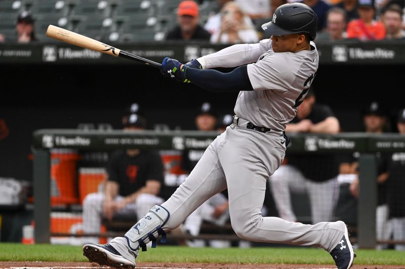 Jul 12, 2024; Baltimore, Maryland, USA;  New York Yankees outfielder Juan Soto (22) singles during the first inning against the Baltimore Orioles at Oriole Park at Camden Yards. Mandatory Credit: Tommy Gilligan-USA TODAY Sports