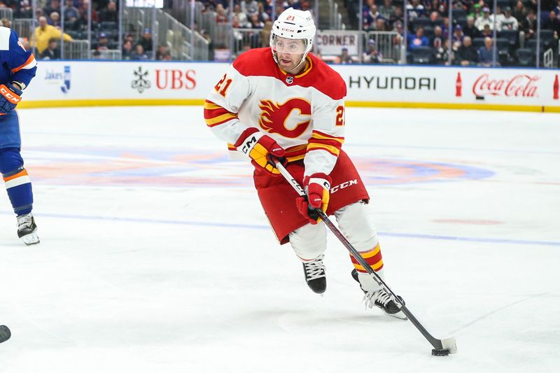 Feb 10, 2024; Elmont, New York, USA;  Calgary Flames center Kevin Rooney (21) controls the puck in the third period New York Islanders at UBS Arena. Mandatory Credit: Wendell Cruz-USA TODAY Sports