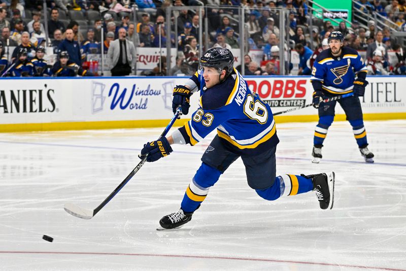 Mar 19, 2024; St. Louis, Missouri, USA;  St. Louis Blues left wing Jake Neighbours (63) shoots against the Colorado Avalanche during the second period at Enterprise Center. Mandatory Credit: Jeff Curry-USA TODAY Sports