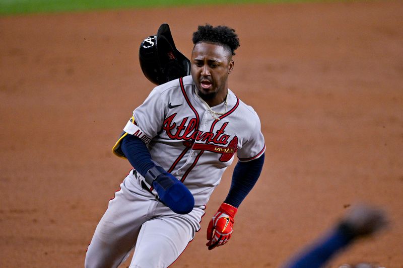 May 16, 2023; Arlington, Texas, USA; Atlanta Braves second baseman Ozzie Albies (1) scores a run from second base during the second inning against the Texas Rangers at Globe Life Field. Mandatory Credit: Jerome Miron-USA TODAY Sports