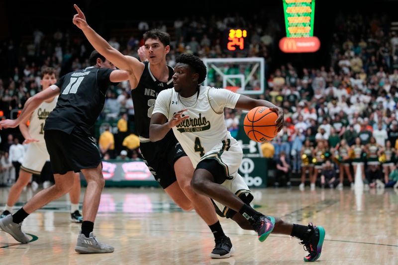 Feb 27, 2024; Fort Collins, Colorado, USA; Colorado State Rams guard Isaiah Stevens (4) drives against Nevada Wolf Pack guard Daniel Foster (20) during the second half at Moby Arena. Mandatory Credit: Michael Madrid-USA TODAY Sports