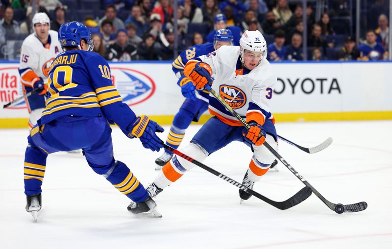 Mar 14, 2024; Buffalo, New York, USA;  New York Islanders center Kyle MacLean (32) skates with the puck as Buffalo Sabres defenseman Henri Jokiharju (10) defends during the first period at KeyBank Center. Mandatory Credit: Timothy T. Ludwig-USA TODAY Sports