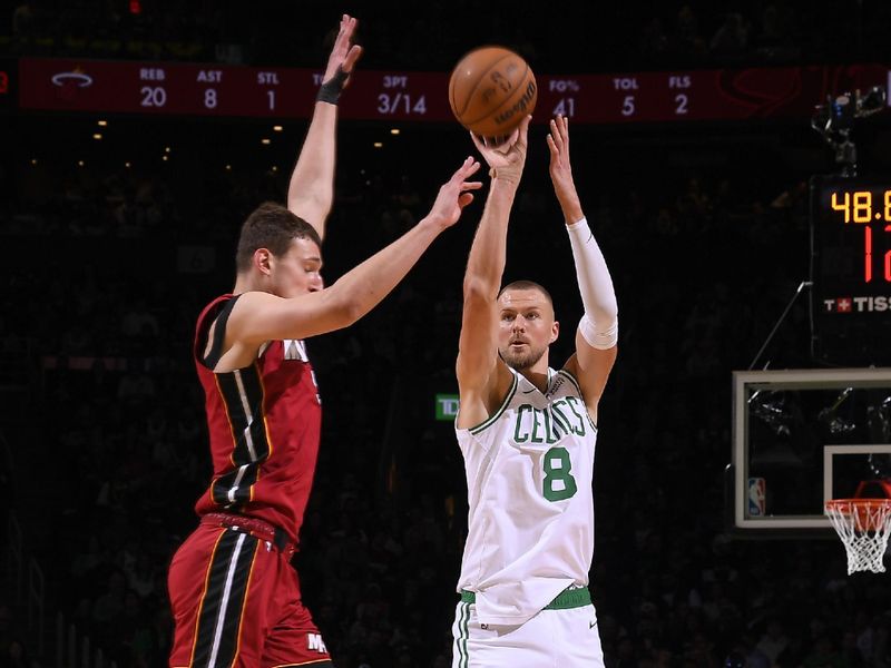 BOSTON, MA - APRIL 21: Kristaps Porzingis #8 of the Boston Celtics shoots a three point basket against the Miami Heat during Round 1 Game 1 of the 2024 NBA Playoffs on April 21, 2024 at the TD Garden in Boston, Massachusetts. NOTE TO USER: User expressly acknowledges and agrees that, by downloading and or using this photograph, User is consenting to the terms and conditions of the Getty Images License Agreement. Mandatory Copyright Notice: Copyright 2024 NBAE  (Photo by Brian Babineau/NBAE via Getty Images)