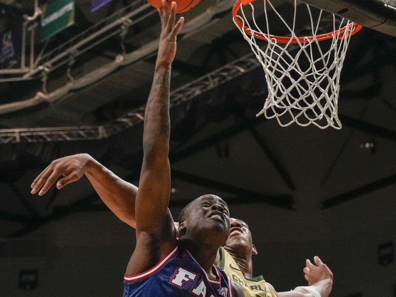 Jan 6, 2024; Charlotte, North Carolina, USA; Florida Atlantic Owls guard Johnell Davis (1) shoots defended by Charlotte 49ers center Dishon Jackson (1) during the second half at Dale F. Halton Arena. Mandatory Credit: Jim Dedmon-USA TODAY Sports