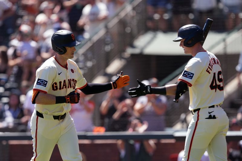 Sep 1, 2024; San Francisco, California, USA; San Francisco Giants right fielder Mike Yastrzemski (left) is congratulated by shortstop Tyler Fitzgerald (49) after hitting a home run against the Miami Marlins during the first inning at Oracle Park. Mandatory Credit: Darren Yamashita-USA TODAY Sports