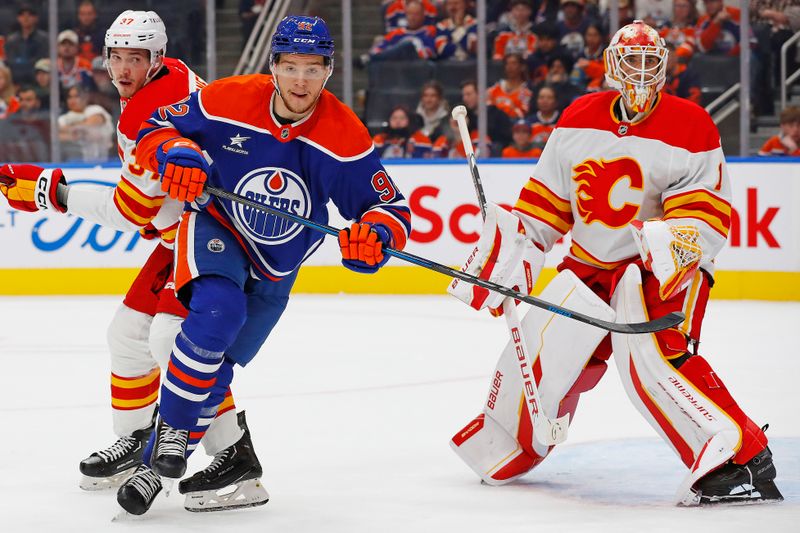 Sep 23, 2024; Edmonton, Alberta, CAN; Edmonton Oilers forward Vasily Podkolzin (92) looks for a loose puck in front of Calgary Flames goaltender Devin Cooley (1) during the first period at Rogers Place. Mandatory Credit: Perry Nelson-Imagn Images