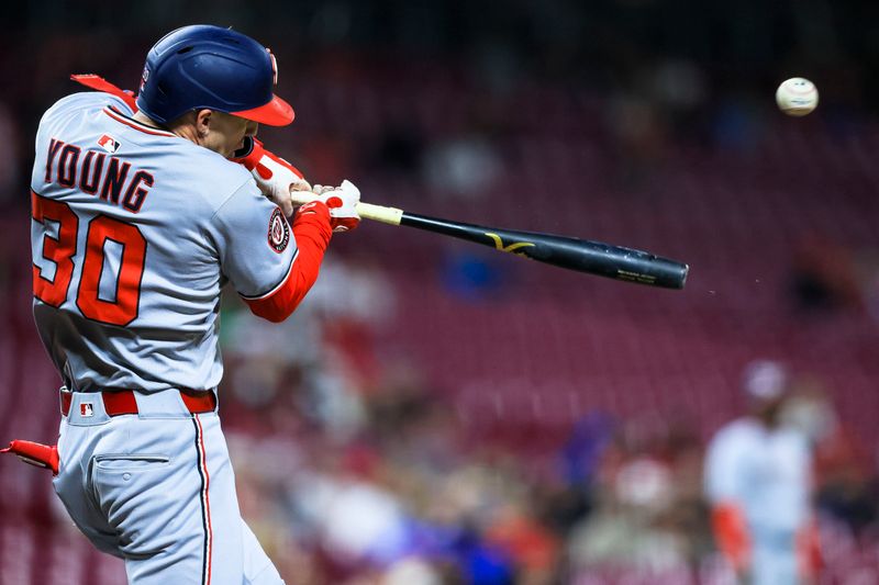May 2, 2025; Cincinnati, Ohio, USA; Washington Nationals outfielder Jacob Young (30) hits a single in the eighth inning against the Cincinnati Reds at Great American Ball Park. Mandatory Credit: Katie Stratman-Imagn Images