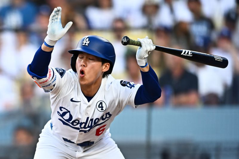 Jun 1, 2025; Los Angeles, California, USA; Los Angeles Dodgers second base Hyeseong Kim (6) dodges a ball against the New York Yankees during the eighth inning at Dodger Stadium. Mandatory Credit: Jonathan Hui-Imagn Images