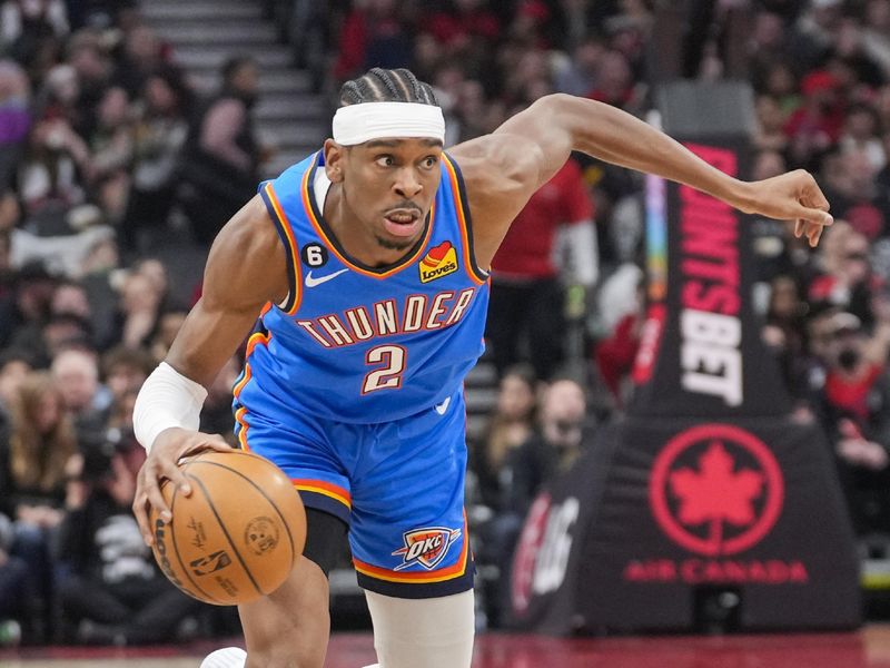 TORONTO, ON - MARCH 16: Shai Gilgeous-Alexander #2 of the Oklahoma City Thunder dribbles against the Toronto Raptors during the first half of their basketball game at the Scotiabank Arena on March 16, 2023 in Toronto, Ontario, Canada. NOTE TO USER: User expressly acknowledges and agrees that, by downloading and/or using this Photograph, user is consenting to the terms and conditions of the Getty Images License Agreement. (Photo by Mark Blinch/Getty Images)