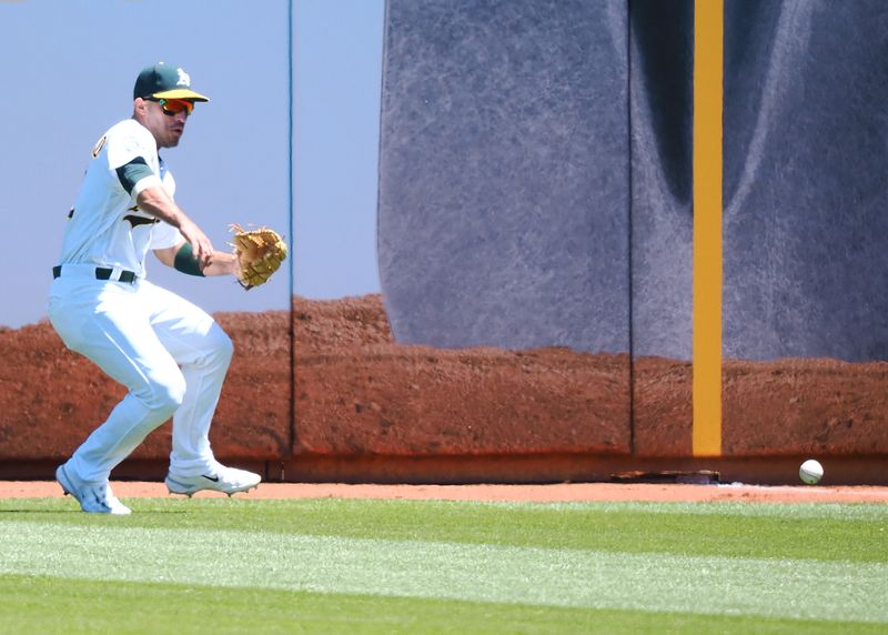 May 17, 2023; Oakland, California, USA; Oakland Athletics right fielder Ramon Laureano (22) gathers the ball during the fifth inning against the Arizona Diamondbacks at Oakland-Alameda County Coliseum. Mandatory Credit: Kelley L Cox-USA TODAY Sports