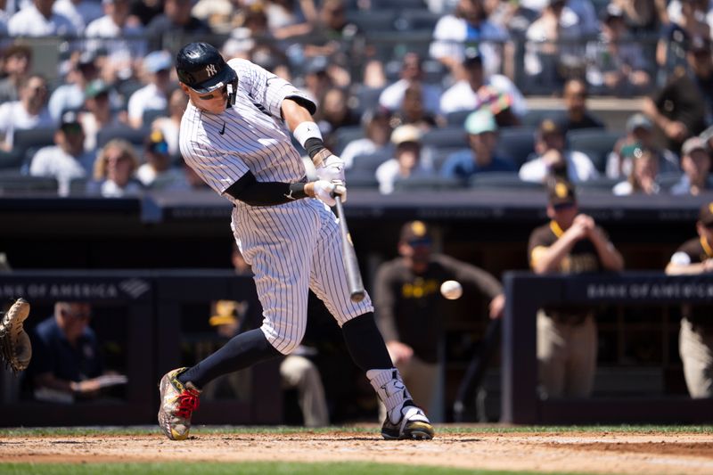 May 28, 2023; Bronx, New York, USA; New York Yankees right fielder Aaron Judge (99) hits an RBI single against the San Diego Padres during the third inning at Yankee Stadium. Mandatory Credit: Gregory Fisher-USA TODAY Sports