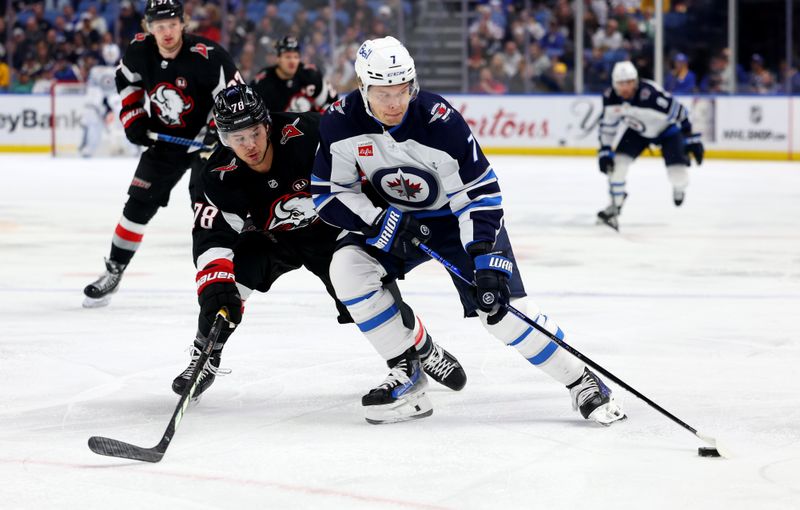 Mar 3, 2024; Buffalo, New York, USA;  Winnipeg Jets center Vladislav Namestnikov (7) carries the puck as Buffalo Sabres defenseman Jacob Bryson (78) defends during the first period at KeyBank Center. Mandatory Credit: Timothy T. Ludwig-USA TODAY Sports