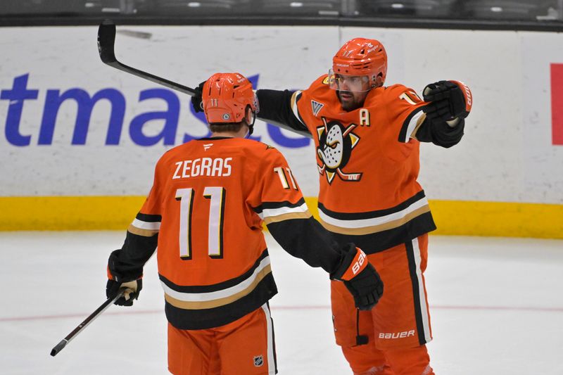 Jan 25, 2025; Anaheim, California, USA; Anaheim Ducks center Trevor Zegras (11) is congratulated by left wing Alex Killorn (17) after scoring a goal in the second period against the Nashville Predators at Honda Center. Mandatory Credit: Jayne Kamin-Oncea-Imagn Images