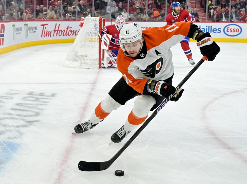 Apr 9, 2024; Montreal, Quebec, CAN; Philadelphia Flyers forward Travis Konecny (11) plays the puck during the first period of the game against the Montreal Canadiens at the Bell Centre. Mandatory Credit: Eric Bolte-USA TODAY Sports