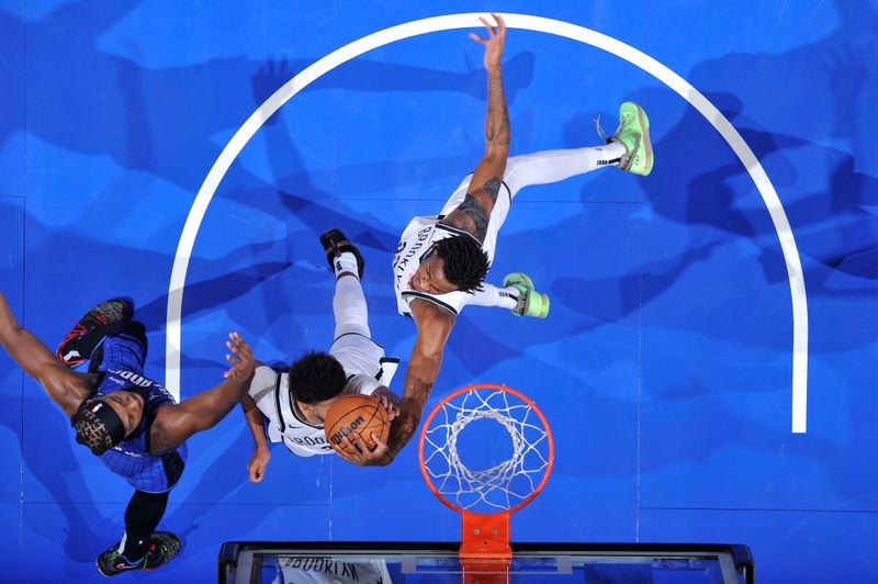 ORLANDO, FL - OCTOBER 25: Nicolas Claxton #33 of the Brooklyn Nets rebounds the ball during the game against the Orlando Magic on October 25, 2024 at Kia Center in Orlando, Florida. NOTE TO USER: User expressly acknowledges and agrees that, by downloading and or using this photograph, User is consenting to the terms and conditions of the Getty Images License Agreement. Mandatory Copyright Notice: Copyright 2024 NBAE (Photo by Fernando Medina/NBAE via Getty Images)