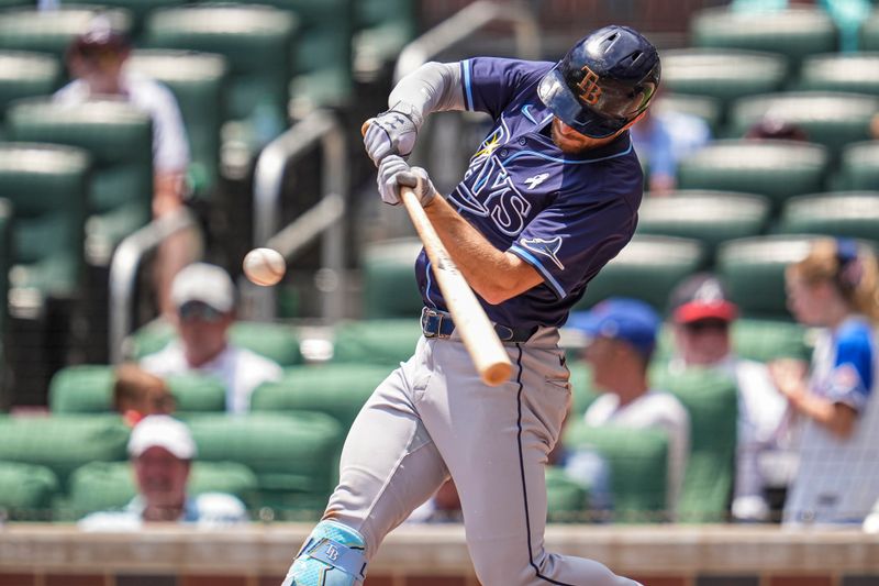 Jun 16, 2024; Cumberland, Georgia, USA; Tampa Bay Rays second baseman Brandon Lowe (8) hits a home run against the Atlanta Braves during the third inning at Truist Park. Mandatory Credit: Dale Zanine-USA TODAY Sports