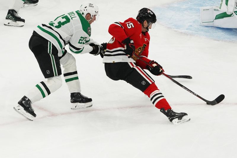 Jan 1, 2026; Chicago, Illinois, USA; Dallas Stars defenseman Esa Lindell (23) defends Chicago Blackhawks right wing Ilya Mikheyev (95) during the second period at United Center. Mandatory Credit: David Banks-Imagn Images