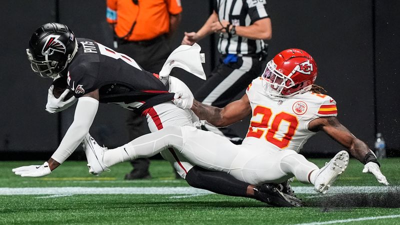 Atlanta Falcons tight end Kyle Pitts (8) makes the catch against Kansas City Chiefs safety Justin Reid (20) during the first half of an NFL football game, Sunday, Sept. 22, 2024, in Atlanta. (AP Photo/Brynn Anderson)