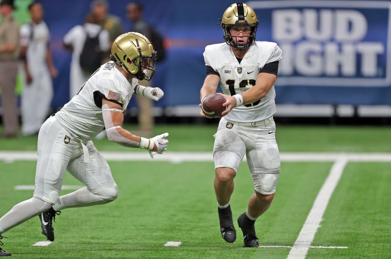 Sep 15, 2023; San Antonio, Texas, USA; Army Black Knights quarterback Bryson Daily (13) hands off the ball during warmups before the first half against the UTSA Roadrunners at the Alamodome. Mandatory Credit: Danny Wild-USA TODAY Sports