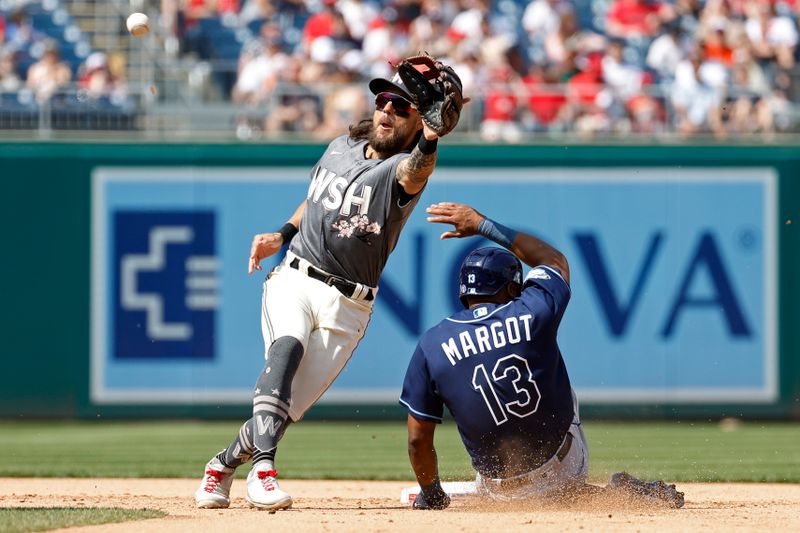 Apr 5, 2023; Washington, District of Columbia, USA; Tampa Bay Rays right fielder Manuel Margot (13) steals second base ahead of a throw to Washington Nationals first baseman Michael Chavis (6) during the sixth inning at Nationals Park. Mandatory Credit: Geoff Burke-USA TODAY Sports