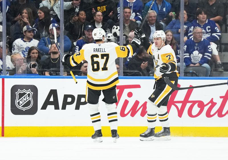 Oct 12, 2024; Toronto, Ontario, CAN; Pittsburgh Penguins right wing Rickard Rakell (67) scores a goal and celebrates with center Evgeni Malkin (71) during the third period against the Toronto Maple Leafs at Scotiabank Arena. Mandatory Credit: Nick Turchiaro-Imagn Images