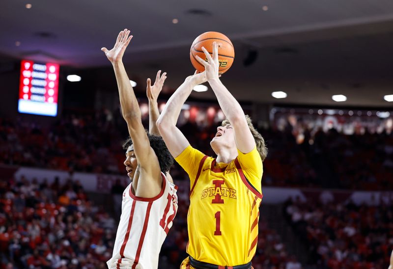 Jan 6, 2024; Norman, Oklahoma, USA; Iowa State Cyclones guard Jackson Paveletzke (1) shoots against Oklahoma Sooners guard Milos Uzan (12) during the first half at Lloyd Noble Center. Mandatory Credit: Alonzo Adams-USA TODAY Sports