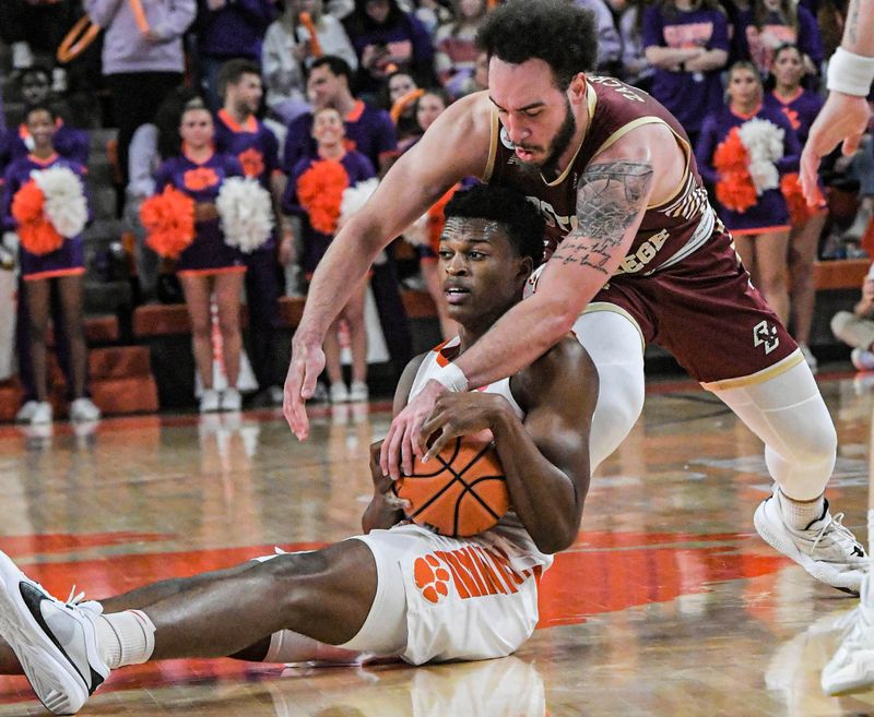 Jan 13, 2024; Clemson, South Carolina, USA; Clemson Tigers forward RJ Godfrey (10) holds on to a ball against Boston College Eagles guard Jaeden Zackery (3) during the second half at Littlejohn Coliseum. Mandatory Credit: Ken Ruinard-USA TODAY Sports