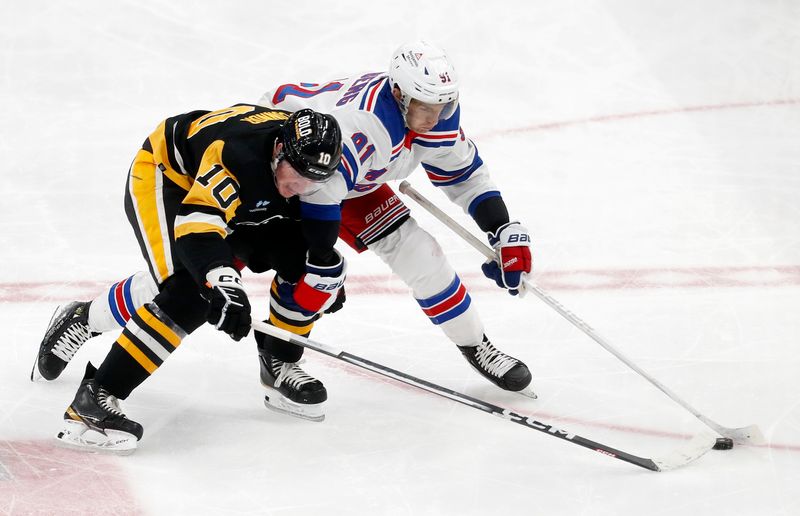 Mar 16, 2024; Pittsburgh, Pennsylvania, USA;  New York Rangers center Alex Wennberg (91) moves the puck against Pittsburgh Penguins left wing Drew O'Connor (10) during the third period at PPG Paints Arena. New York won 7-4.  Mandatory Credit: Charles LeClaire-USA TODAY Sports