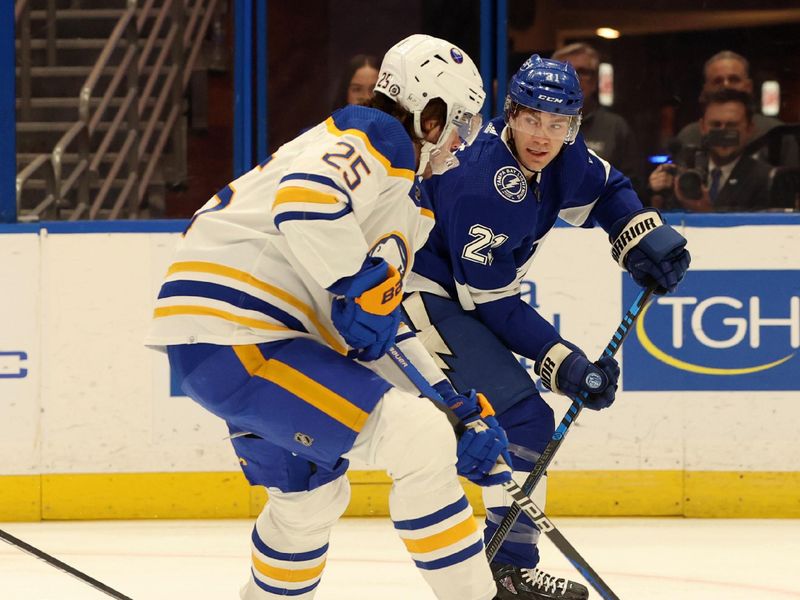 Apr 15, 2024; Tampa, Florida, USA;  Tampa Bay Lightning center Brayden Point (21) passes the puck as Buffalo Sabres defenseman Owen Power (25) defends during the first period at Amalie Arena. Mandatory Credit: Kim Klement Neitzel-USA TODAY Sports