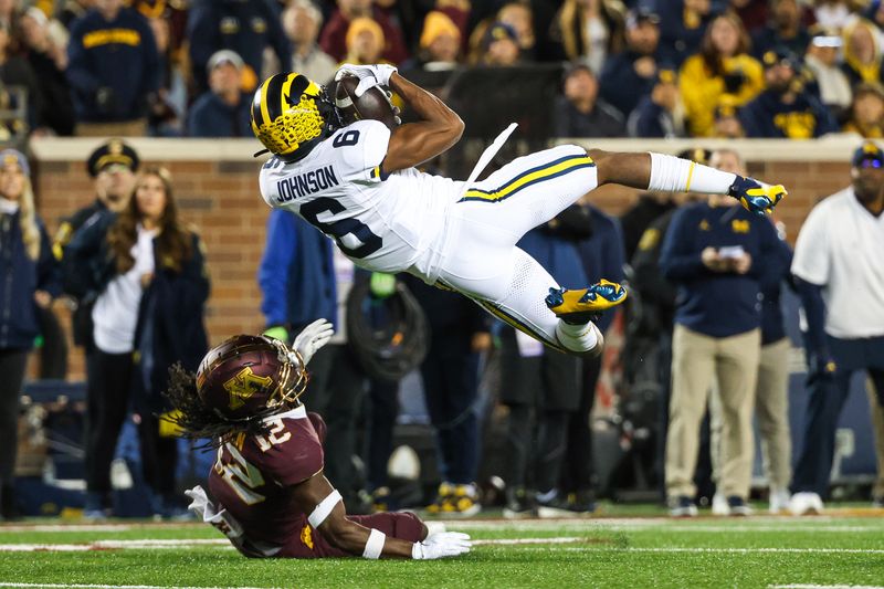 Oct 7, 2023; Minneapolis, Minnesota, USA; Michigan Wolverines wide receiver Cornelius Johnson (6) makes a catch while Minnesota Golden Gophers defensive back Darius Green (12) defends during the second quarter at Huntington Bank Stadium. Mandatory Credit: Matt Krohn-USA TODAY Sports