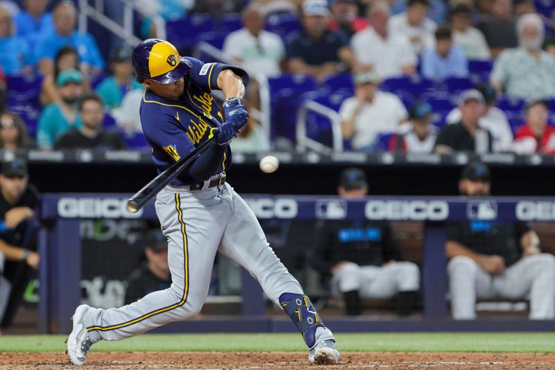 Sep 24, 2023; Miami, Florida, USA; Milwaukee Brewers right fielder Tyrone Taylor (15) hits an RBI single against the Miami Marlins during the fifth inning at loanDepot Park. Mandatory Credit: Sam Navarro-USA TODAY Sports