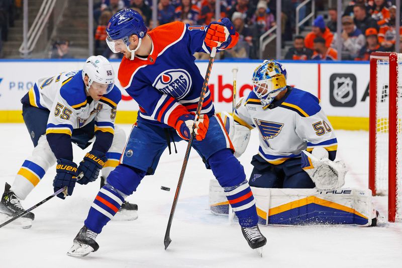 Feb 28, 2024; Edmonton, Alberta, CAN; Edmonton Oilers forward Zach Hyman (18) deflects a shot just wide of St. Louis Blues goaltender Jordan Binnington (50) during the first period at Rogers Place. Mandatory Credit: Perry Nelson-USA TODAY Sports