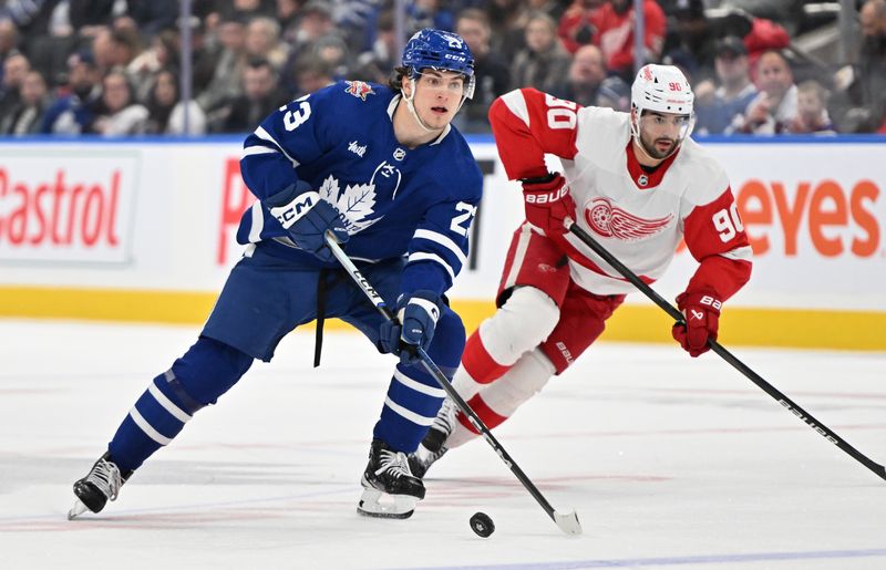 Jan 14, 2024; Toronto, Ontario, CAN;  Toronto Maple Leafs forward Matthew Knies (23) skates with the puck ahead of Detroit Red Wings forward Joe Veleno (90) in the third period at Scotiabank Arena. Mandatory Credit: Dan Hamilton-USA TODAY Sports