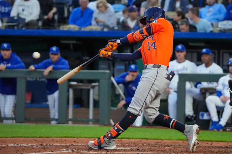 Apr 9, 2024; Kansas City, Missouri, USA; Houston Astros center fielder Mauricio Dubón (14) hits a double against the Kansas City Royals in the fourth inning at Kauffman Stadium. Mandatory Credit: Denny Medley-USA TODAY Sports