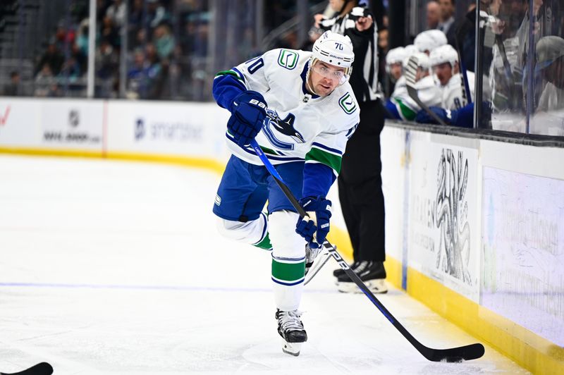 Oct 27, 2022; Seattle, Washington, USA; Vancouver Canucks left wing Tanner Pearson (70) passes the puck against the Seattle Kraken during the second period at Climate Pledge Arena. Mandatory Credit: Steven Bisig-USA TODAY Sports