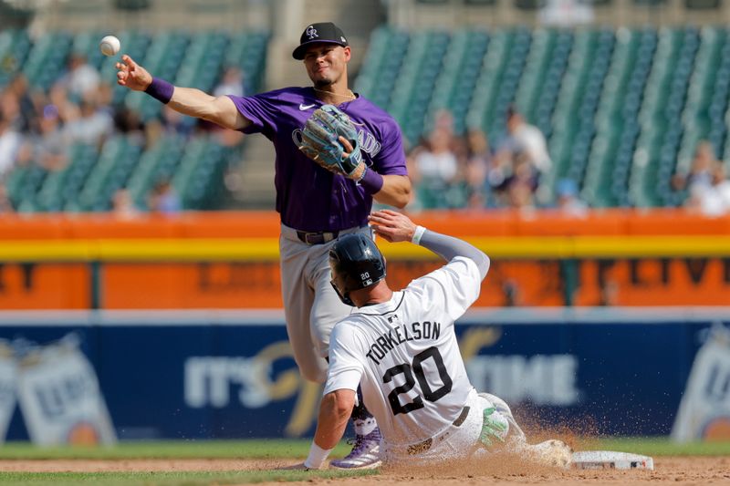 Sep 12, 2024; Detroit, Michigan, USA;  Colorado Rockies shortstop Ezequiel Tovar (14) makes a throw to first to complete a double play as Detroit Tigers first baseman Spencer Torkelson (20) slide into second in the seventh inning at Comerica Park. Mandatory Credit: Rick Osentoski-Imagn Images