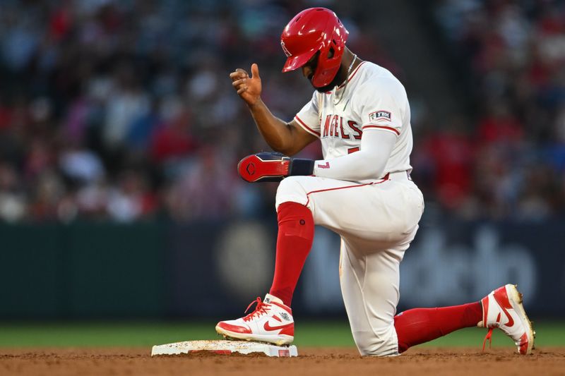 May 25, 2024; Anaheim, California, USA; Los Angeles Angels outfielder Jo Adell (7) reacts after losing a steal against the Cleveland Guardians during the fourth inning at Angel Stadium. Mandatory Credit: Jonathan Hui-USA TODAY Sports