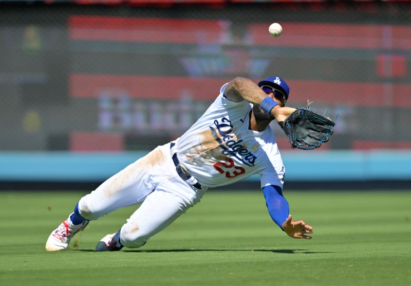 Sep 3, 2023; Los Angeles, California, USA;  Los Angeles Dodgers right fielder Jason Heyward (23) makes a sliding catch off a ball hit by Atlanta Braves second baseman Ozzie Albies (1) in the sixth inning at Dodger Stadium. Mandatory Credit: Jayne Kamin-Oncea-USA TODAY Sports