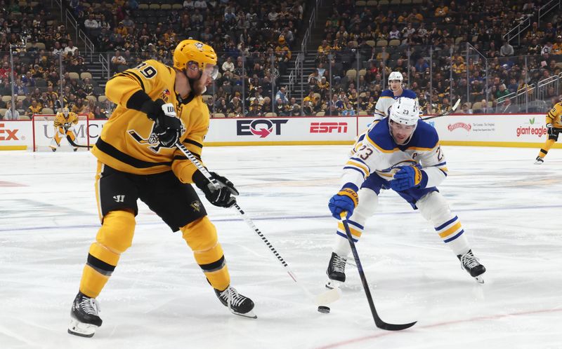 Mar 5, 2026; Pittsburgh, Pennsylvania, USA;  Pittsburgh Penguins right wing Anthony Mantha (39) moves the puck against Buffalo Sabres defenseman Mattias Samuelsson (23) during the first period at PPG Paints Arena. Mandatory Credit: Charles LeClaire-Imagn Images